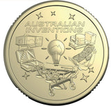 A round commemorative coin featuring the engraved text 'AUSTRALIAN INVENTIONS' and illustrated inventions surrounding a light bulb, shown on a plain white background.