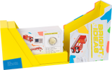 A yellow and white cardboard display box labeled 'Bright Ideas 2016 Science Coin Collection' holding a stack of coin information cards with illustrations and a visible coin insert.
